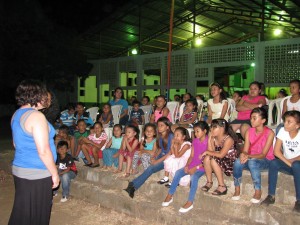 Jessie B. speaking to children while Brenda was speaking to the women and Tom was speaking to the men. 