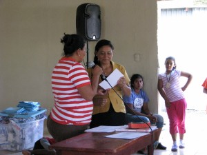 Odily handing out certificates to those who completed the Zookeeper's class 